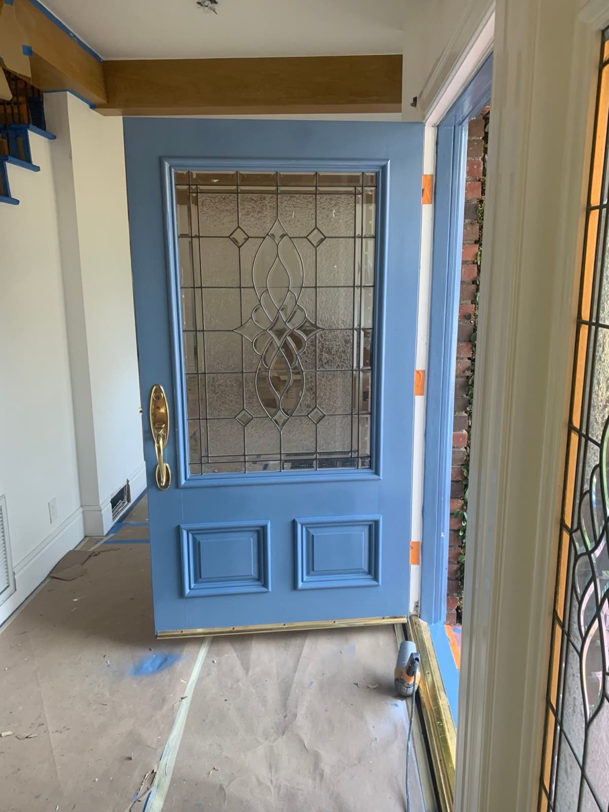 Doorway masked off and floor covered in protective paper before painting