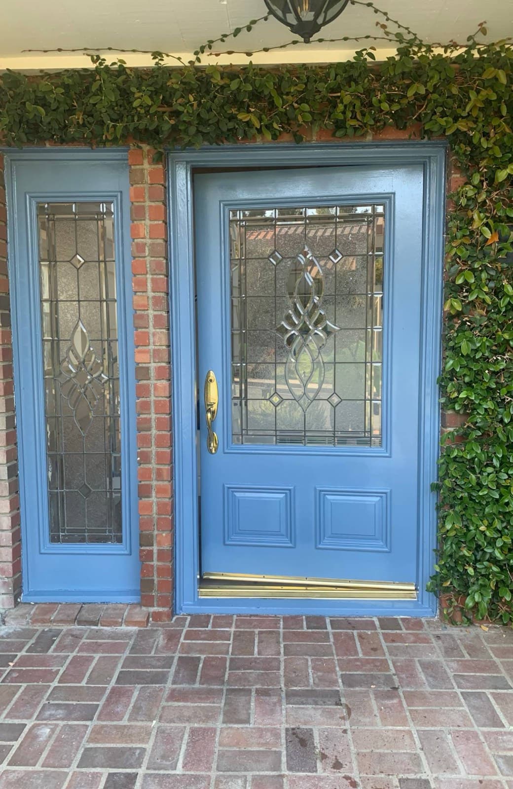 Freshly painted blue front door and sidelight